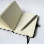 black-notebook-with-pencil-1176000-m