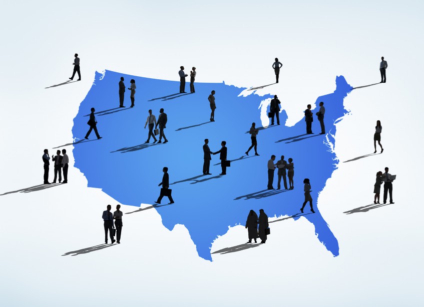 Silhouettes Of Multi-Ethnic Business People On A Blue Cartograph