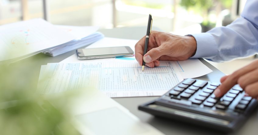 Tax accountant working with documents at table